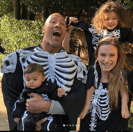 family photo of the rock dwayne johnson with his wife lauren hashian and their two daughters simone and tiana.